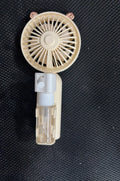 A compact plastic nozzle personal fan in an assortment of colours, showing its USB charging port and slender 6cm width.