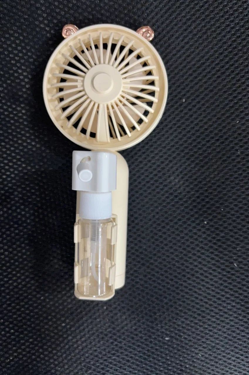 A compact plastic nozzle personal fan in an assortment of colours, showing its USB charging port and slender 6cm width.