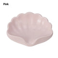 White and pink shell-shaped plastic soap dishes for bathroom countertops.