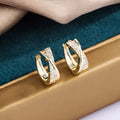 Geometric copper drop earrings with 14K yellow finish and zircon treatment