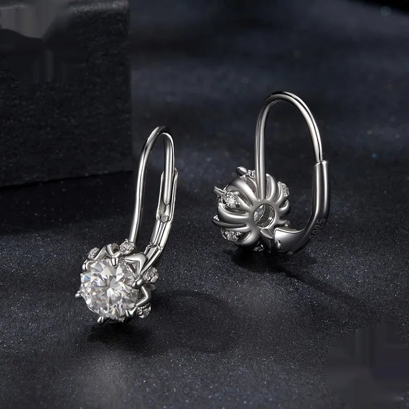 Silver flower bud shaped clip-on earrings with a white gold plated finish and a central moissanite stone.