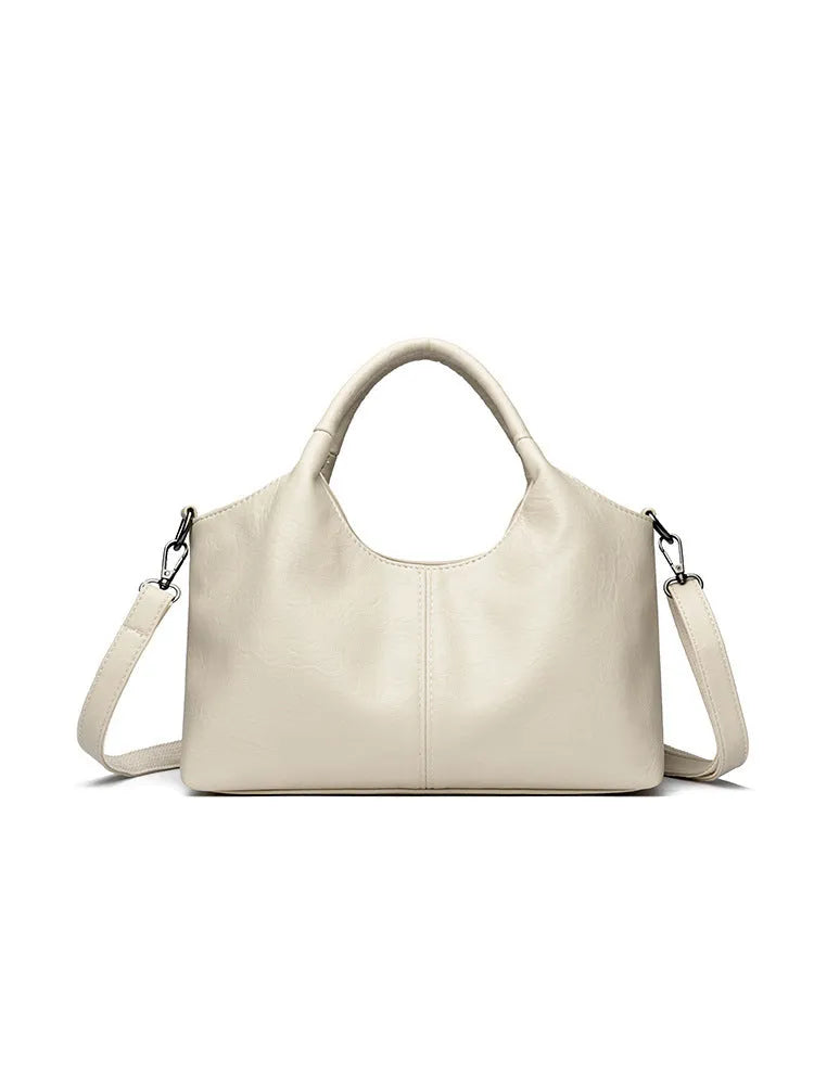 Women's genuine leather cross-body bag in seven colour options showing large capacity main compartment