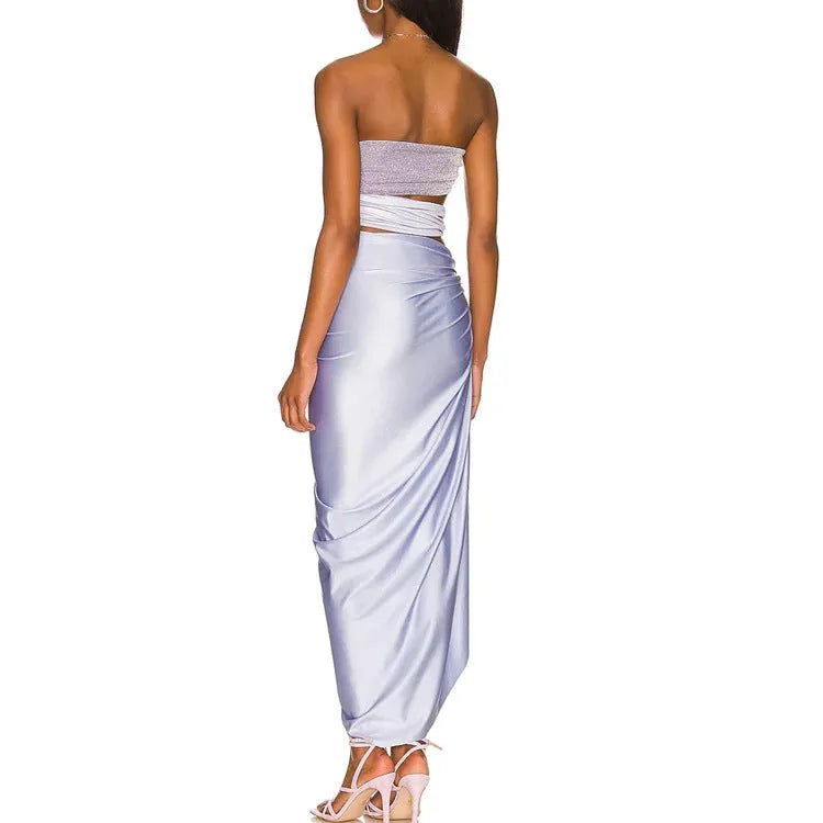 Purple one-piece swimsuit with a matching wrap skirt laid flat on a surface.
