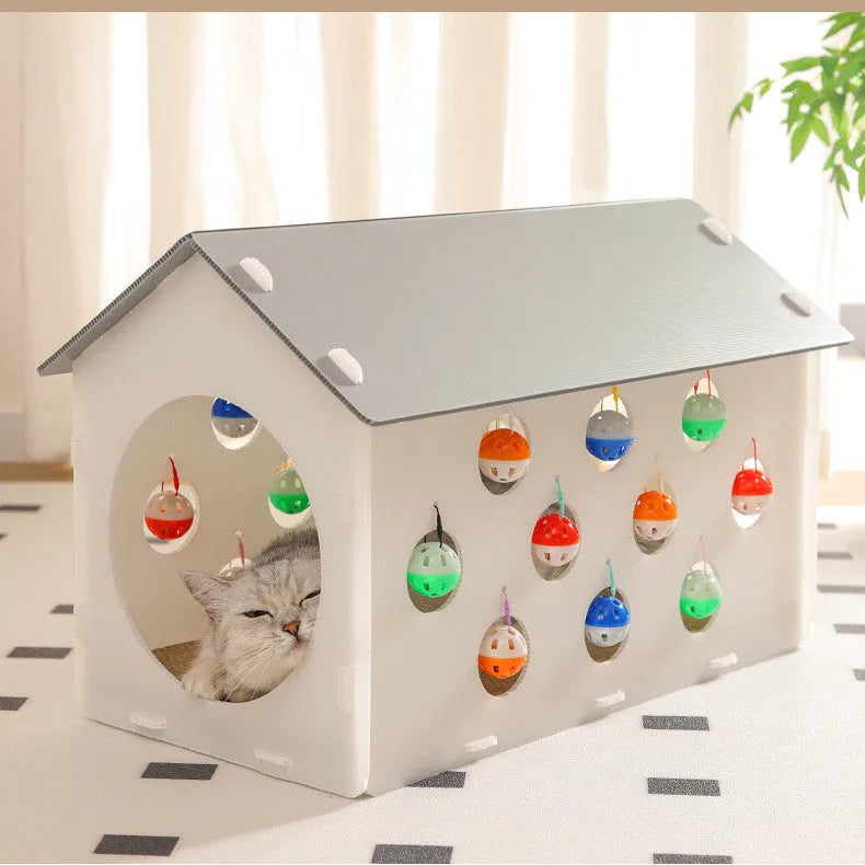 Plastic integrated cat scratch board with attached nest bed and tunnel containing a bell ball toy.