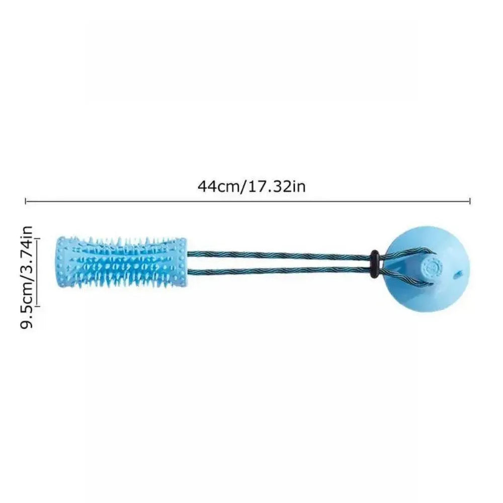 Blue and pink dog chew ball toy with suction cup and food dispenser on tiled floor