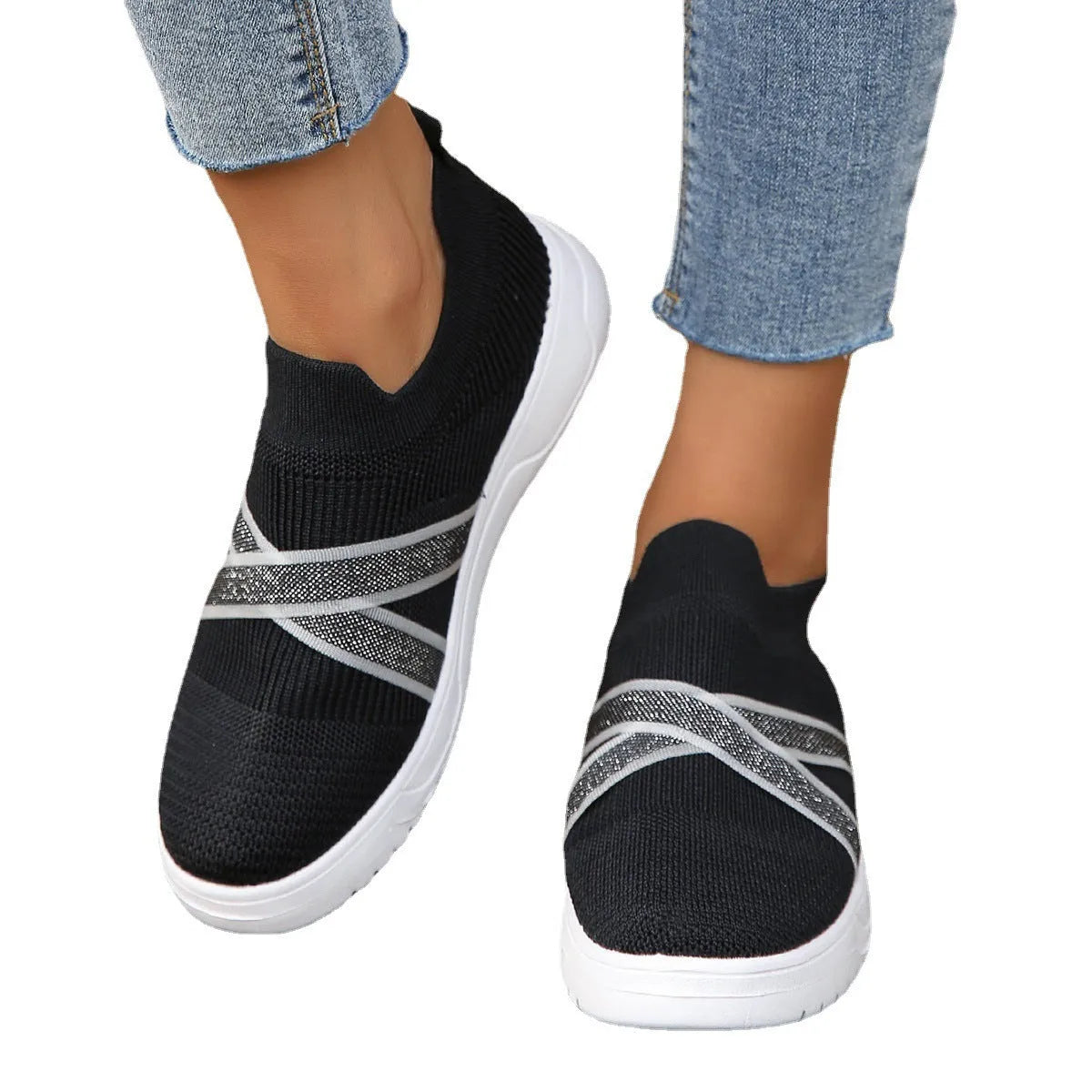 Black women's flat shoes with flyknit mesh fabric upper, rubber sole and tassel detail