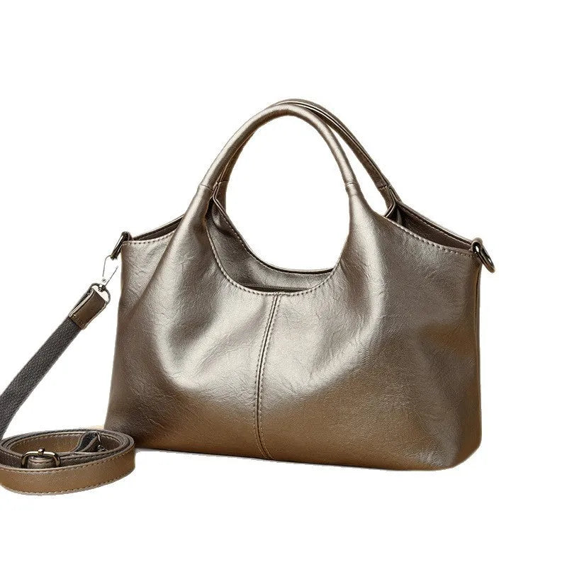 Women's genuine leather cross-body bag in seven colour options showing large capacity main compartment