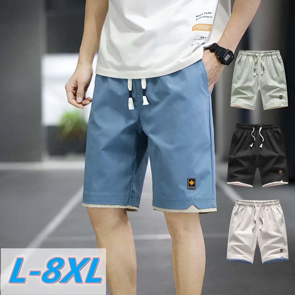 Man wearing loose fit casual polyester shorts in a green colour, showcasing the fifth pants length and Korean style.