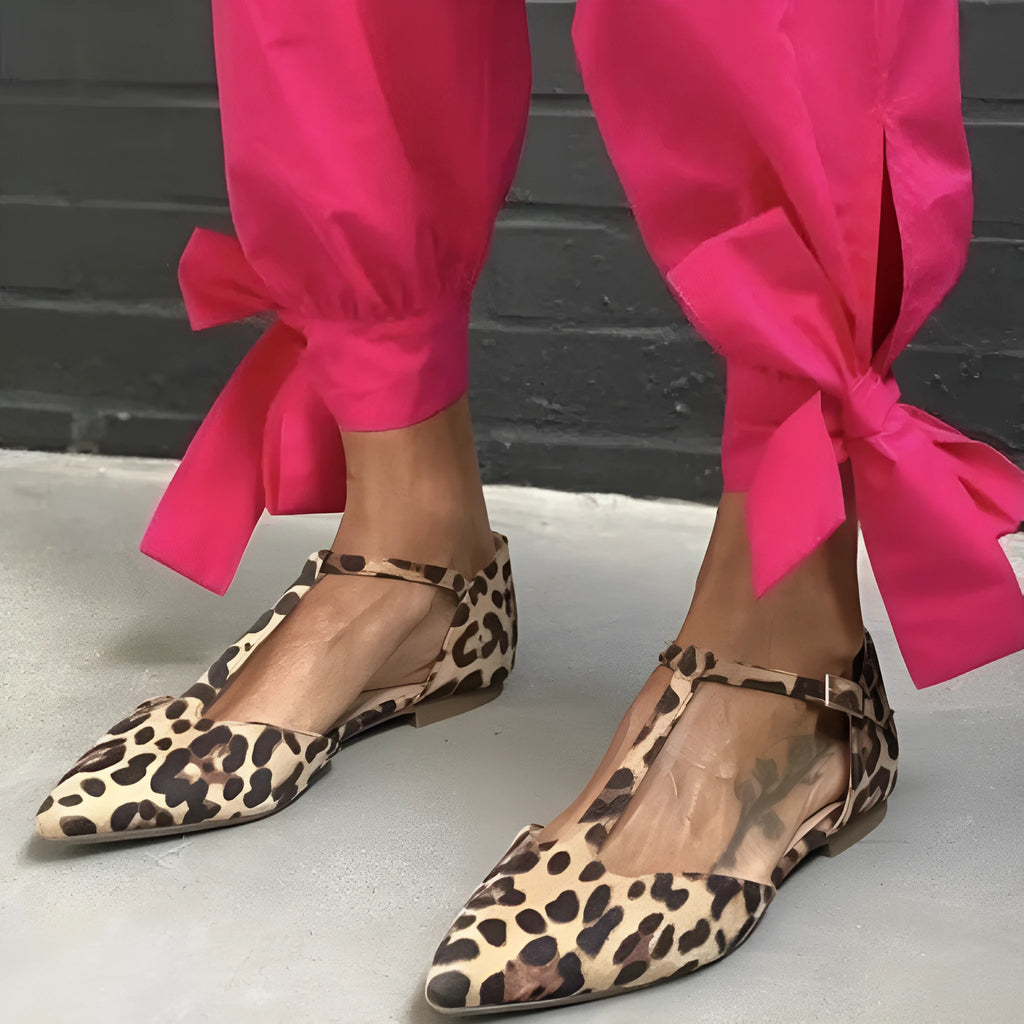 Leopard print women's pumps with pointed toe, chunky low heel, and cross shoulder straps