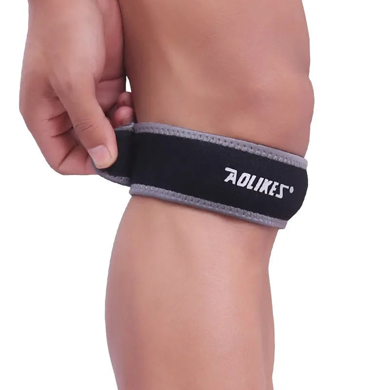 Black and grey adult patella retinaculum knee support for running and sports.