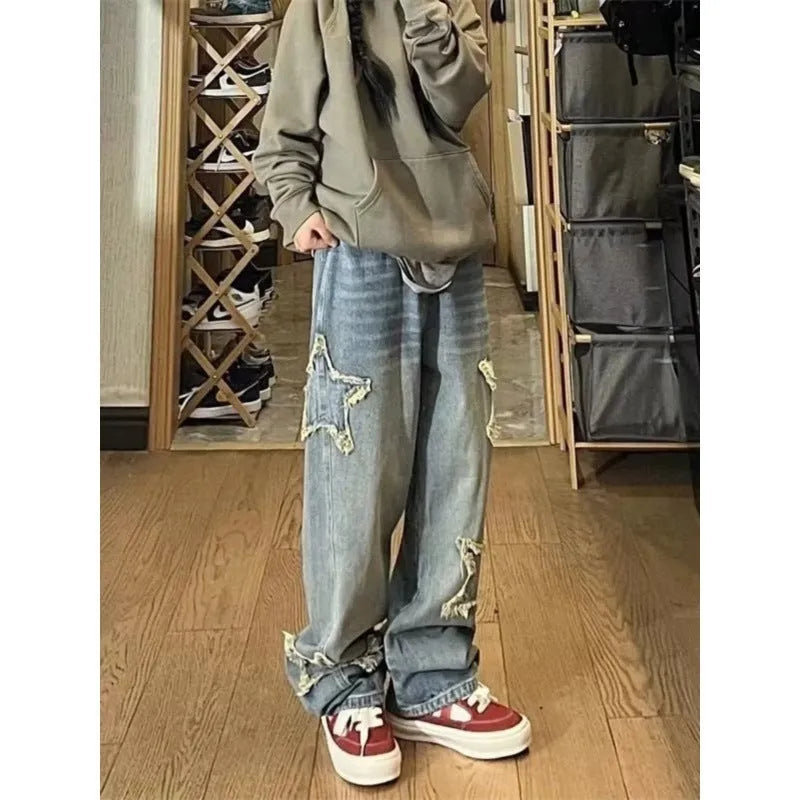 Blue high waist women's wide-leg denim trousers laid flat, showing straight leg cut and button fastening.
