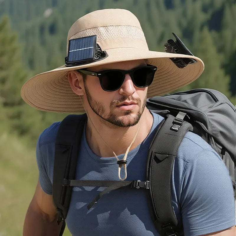 Man wearing a beige wide-brim solar fan hat outdoors, showing the built-in fan and solar panels.