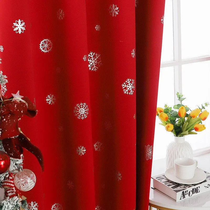 Red snowflake pattern shade cloth curtain with lace loop detailing hung on window