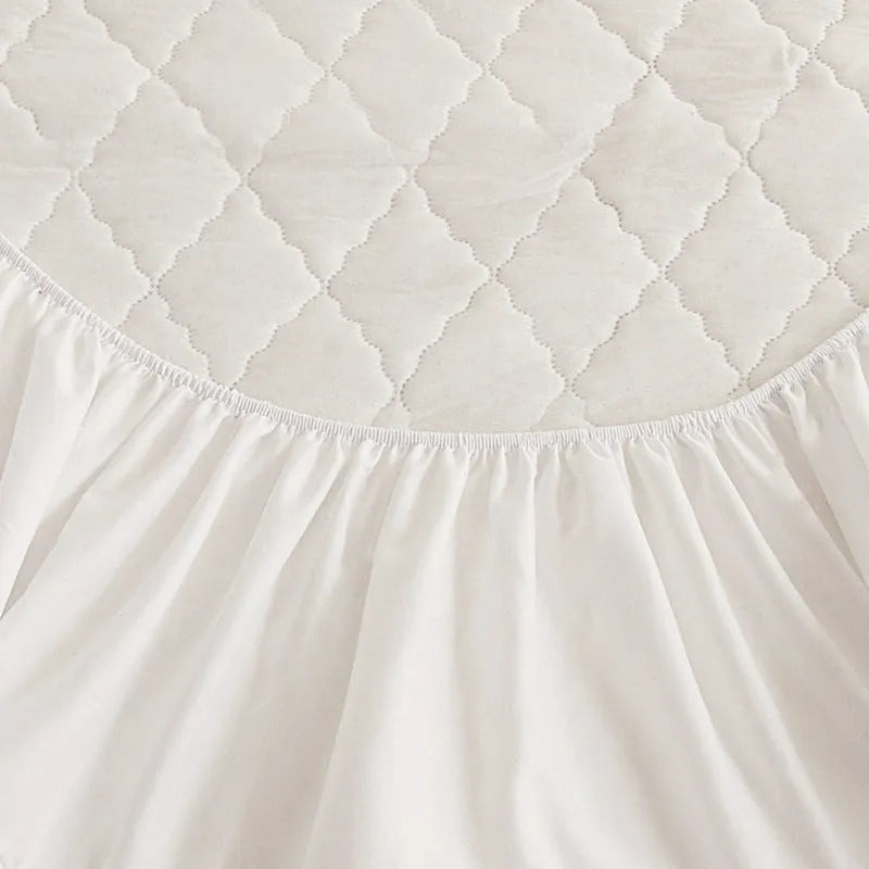Diamond lattice quilted bamboo fibre waterproof mattress protector set with fitted sheet and pillowcases in grey.