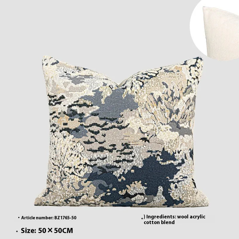 Antique blue abstract floral decorative pillow on a grey sofa, showing square and waist pillow sizes.