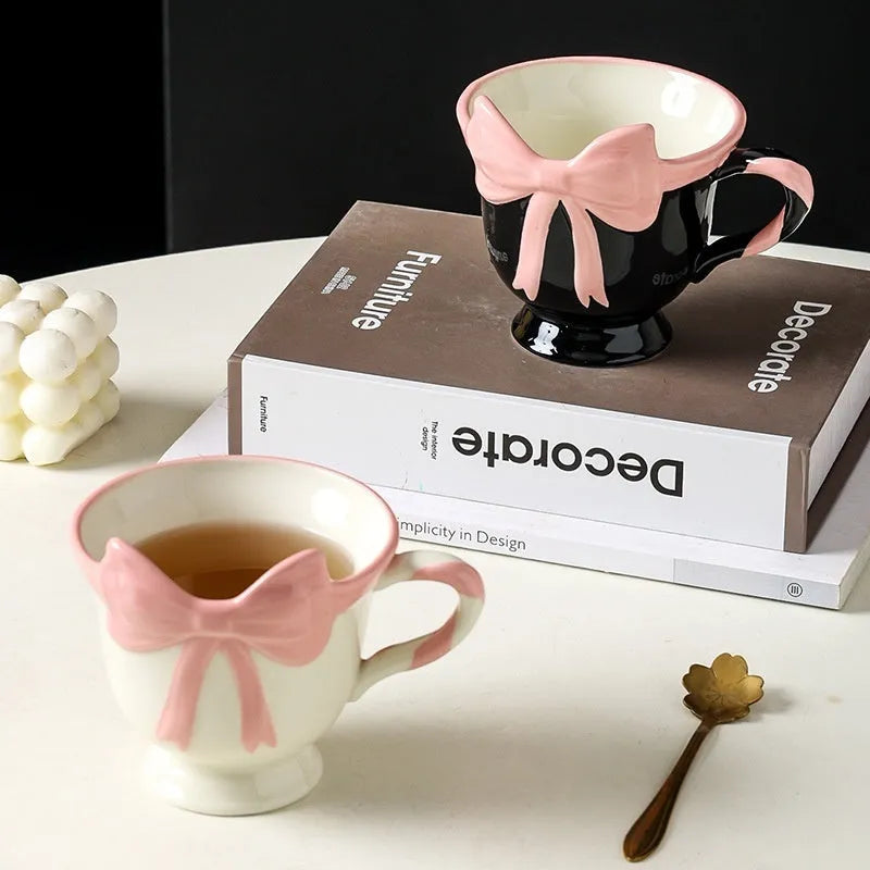 Heart-shaped ceramic mug with decorative bow design in white powder or black pink colour