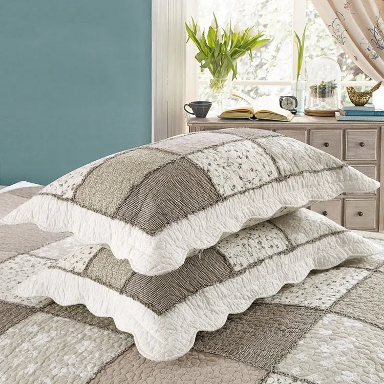 Washed pure cotton quilted bedspread and pillowcase three-piece set in a beige colour pattern on a bed.