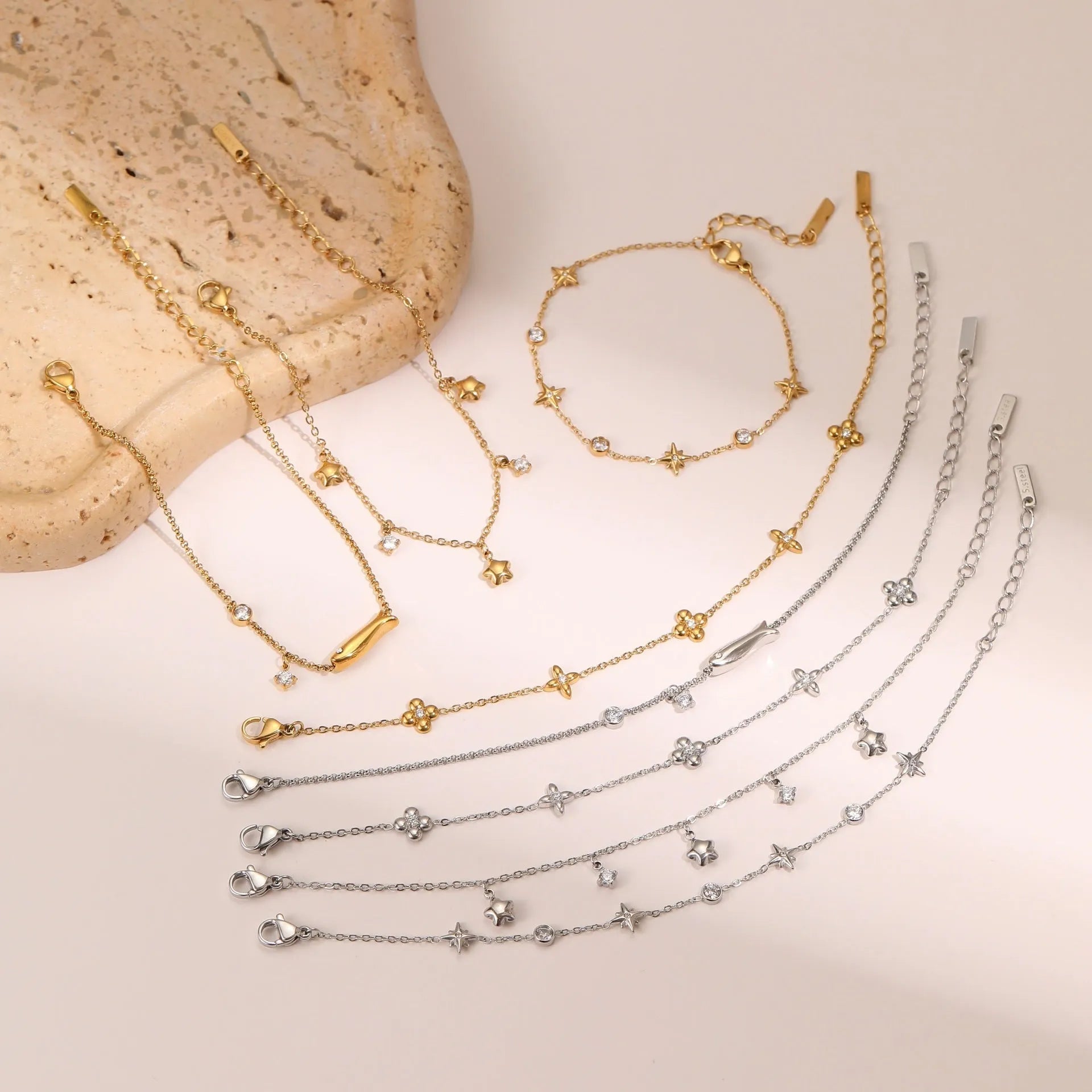 Women's stainless steel bracelet with a geometric star pendant, shown in gold and steel colour finishes.