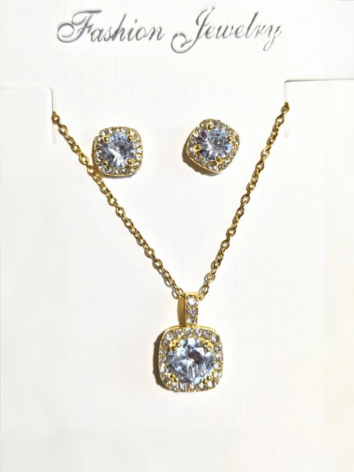 Women's minimalist square cubic zirconia necklace and earring set in gold finish on a light background