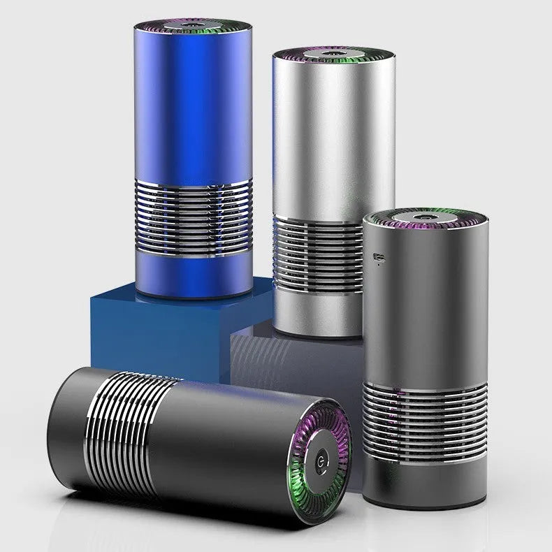 Compact black metallic car air purifier with USB cable on a car dashboard.