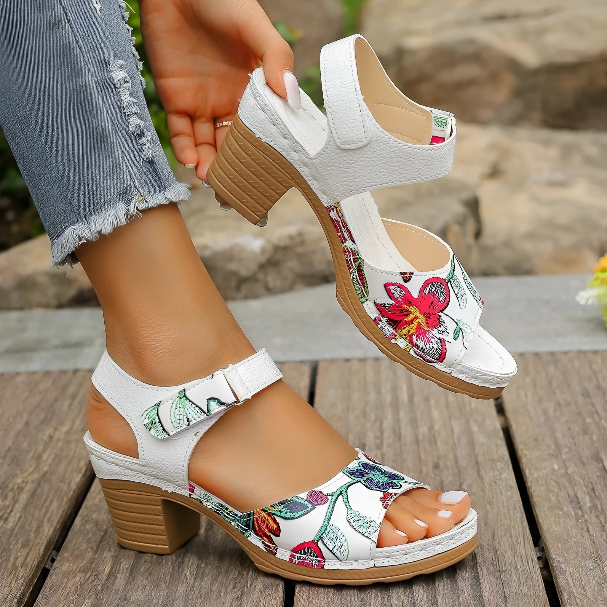 White women's high heel sandals with an adjustable Velcro strap buckle on the ankle.