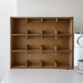 Square wooden storage rack with multiple grid compartments for cups in a birch wood finish.