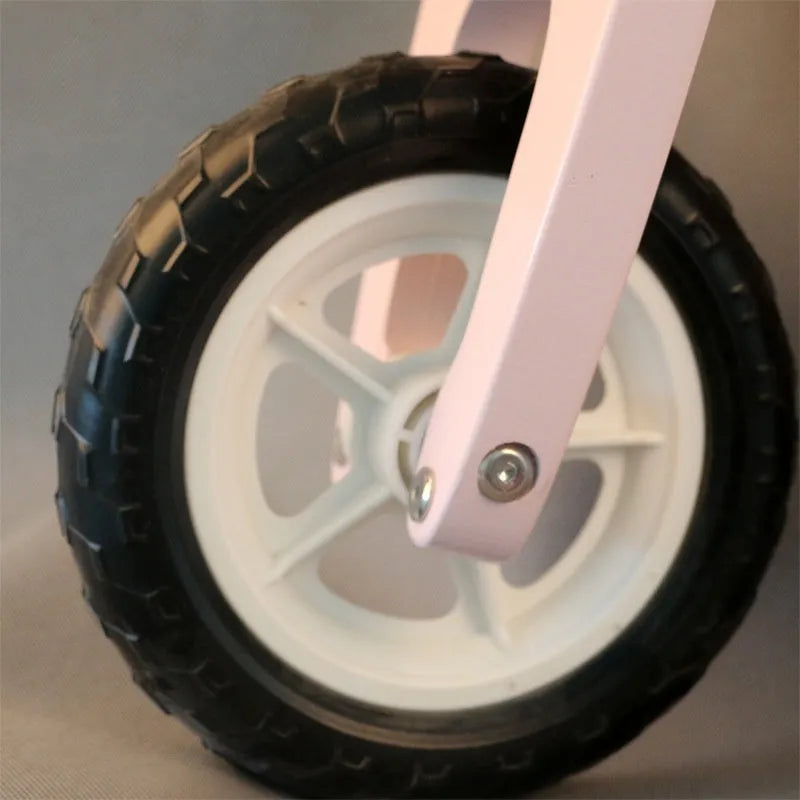 Pink wooden toddler balance scooter on a 10-inch wooden frame for children aged 1-6.