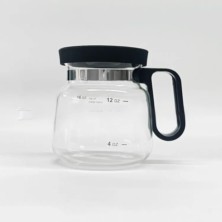 Transparent borosilicate glass coffee maker with a black silicone cover on a wooden table.