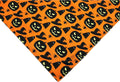 Halloween dog bandana with reversible pumpkin and spider web patterns on black and orange fabric