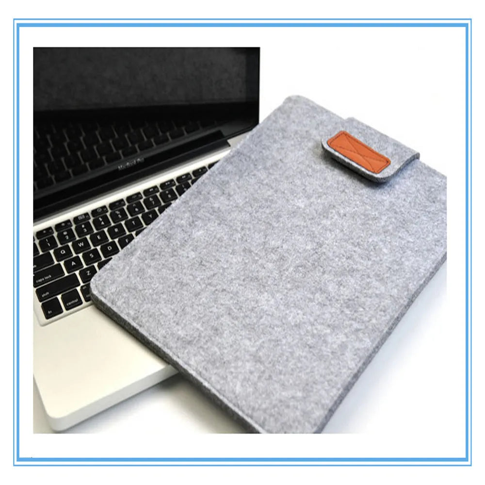 Dark grey clamshell laptop bag open to show plush woven interior lining for a tablet or notebook.