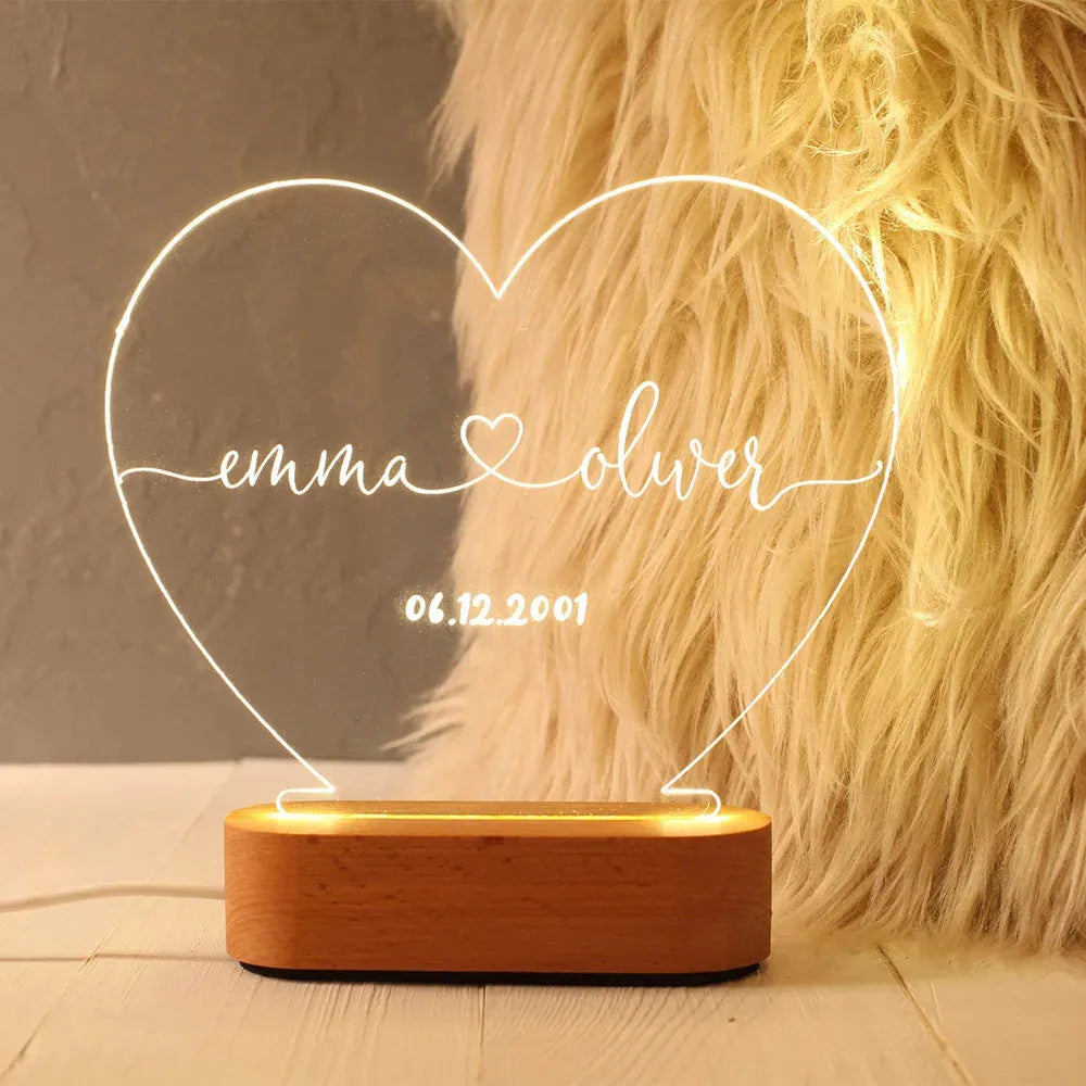 Personalised acrylic night light with engraved names and dates, measuring 20cm by 11.5cm