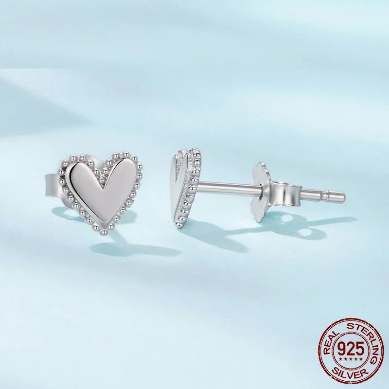 S925 sterling silver heart shaped stud earrings for women, electroplated finish, single pair on white background