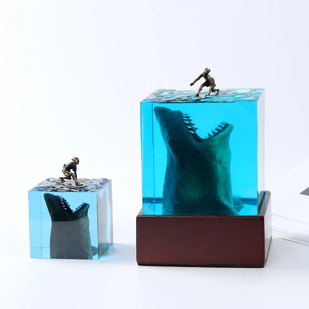 Clear epoxy resin ornament with shark surfer scene inside, next to 5cm and 8cm size options.