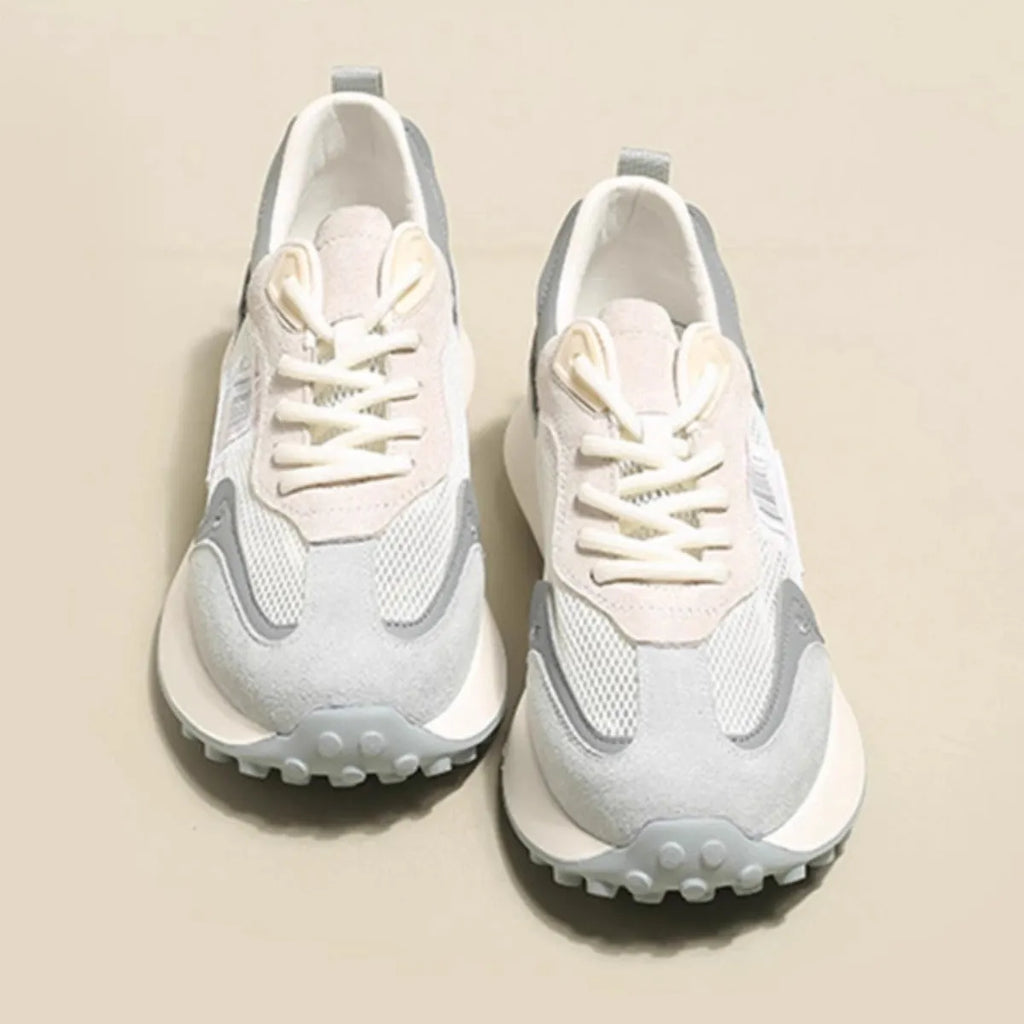 Women's grey and pink low-top retro sneakers with a round toe and flat rubber sole.