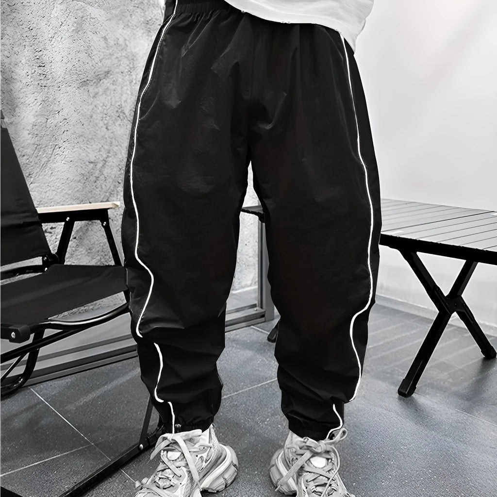 Man wearing loose-fit, cropped-length bamboo fibre sports trousers in Army Green colour.