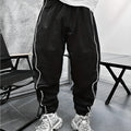 Man wearing loose-fit, cropped-length bamboo fibre sports trousers in Army Green colour.