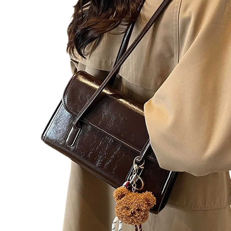 Brown women's PU Maillard handbag with pendant detail, horizontal square shape, and double shoulder straps