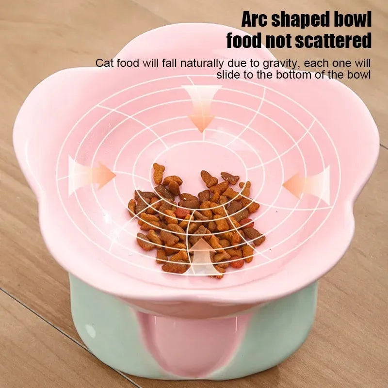 Blue floral patterned ceramic raised pet bowl for cats and dogs on a wooden floor.