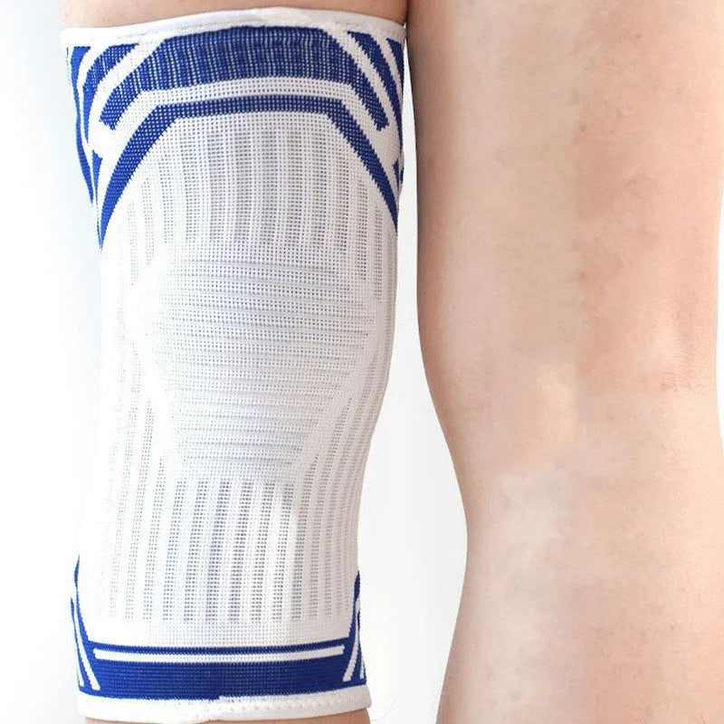 Blue pressurised cotton knee pad for basketball and running sports on adult leg