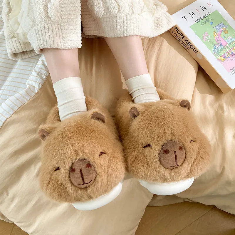 Light brown women's winter plush slippers with cartoon pattern and artificial wool lining.