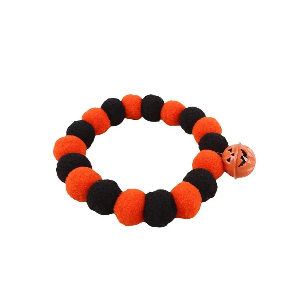 Orange Halloween pumpkin print cat collar with black cat silhouette and green stem.