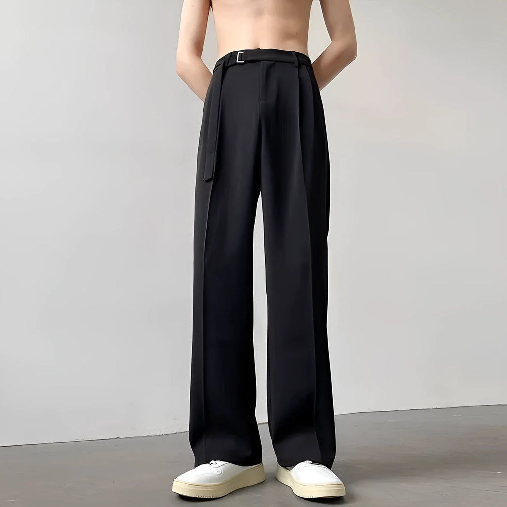 Black wide leg trousers with straight cut and non-iron finish laid flat