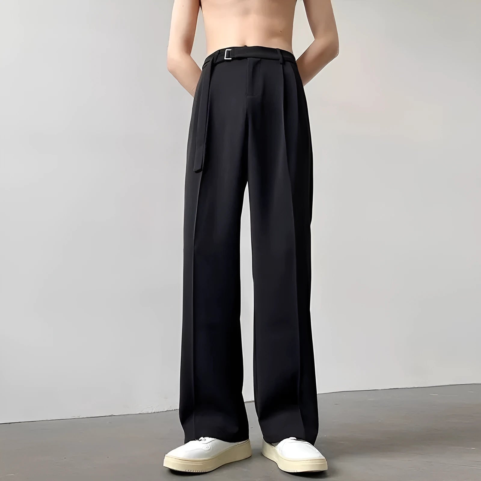 Black wide leg trousers with straight cut and non-iron finish laid flat