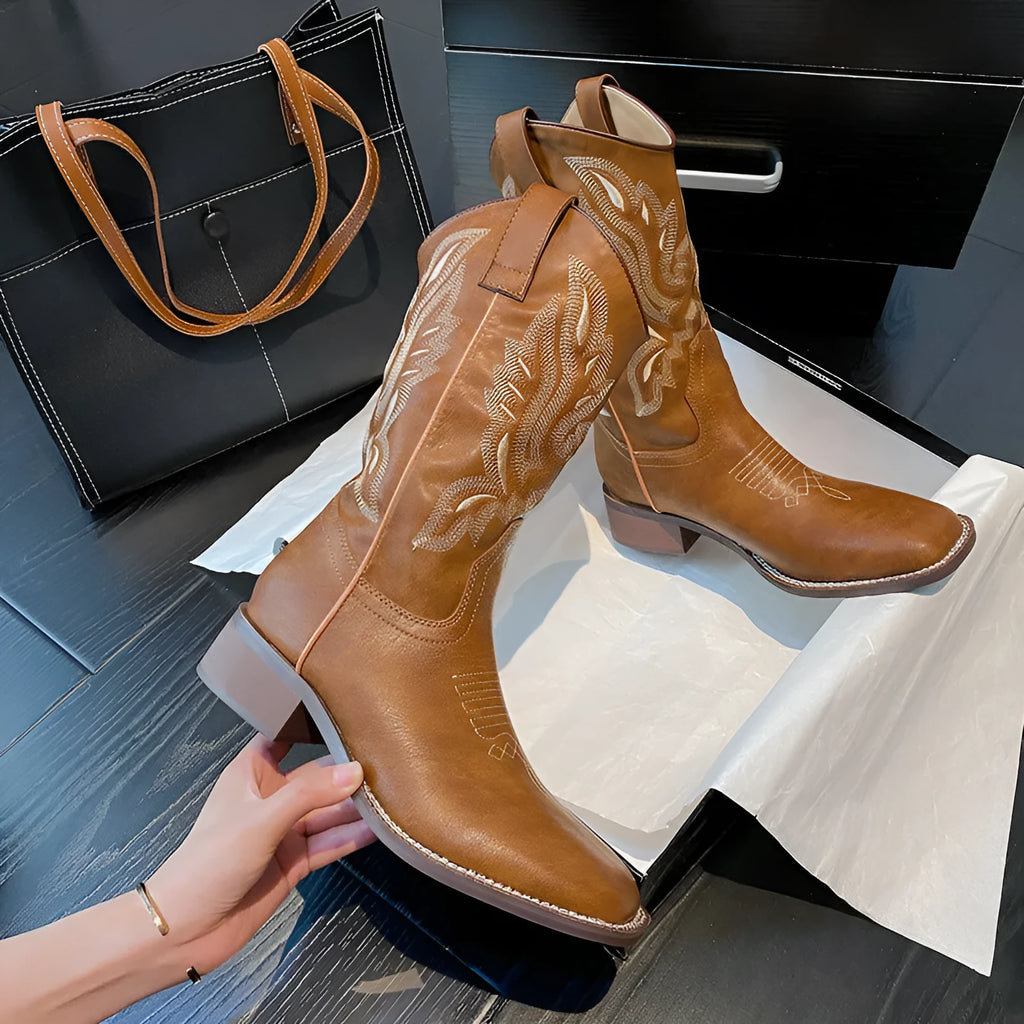 Brown women's embroidered leather mid-calf boots with round toe and low square heel.