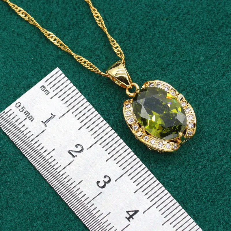 Olive green rhinestone jewellery set with necklace, earrings and ring featuring cross, crown and numeral designs.