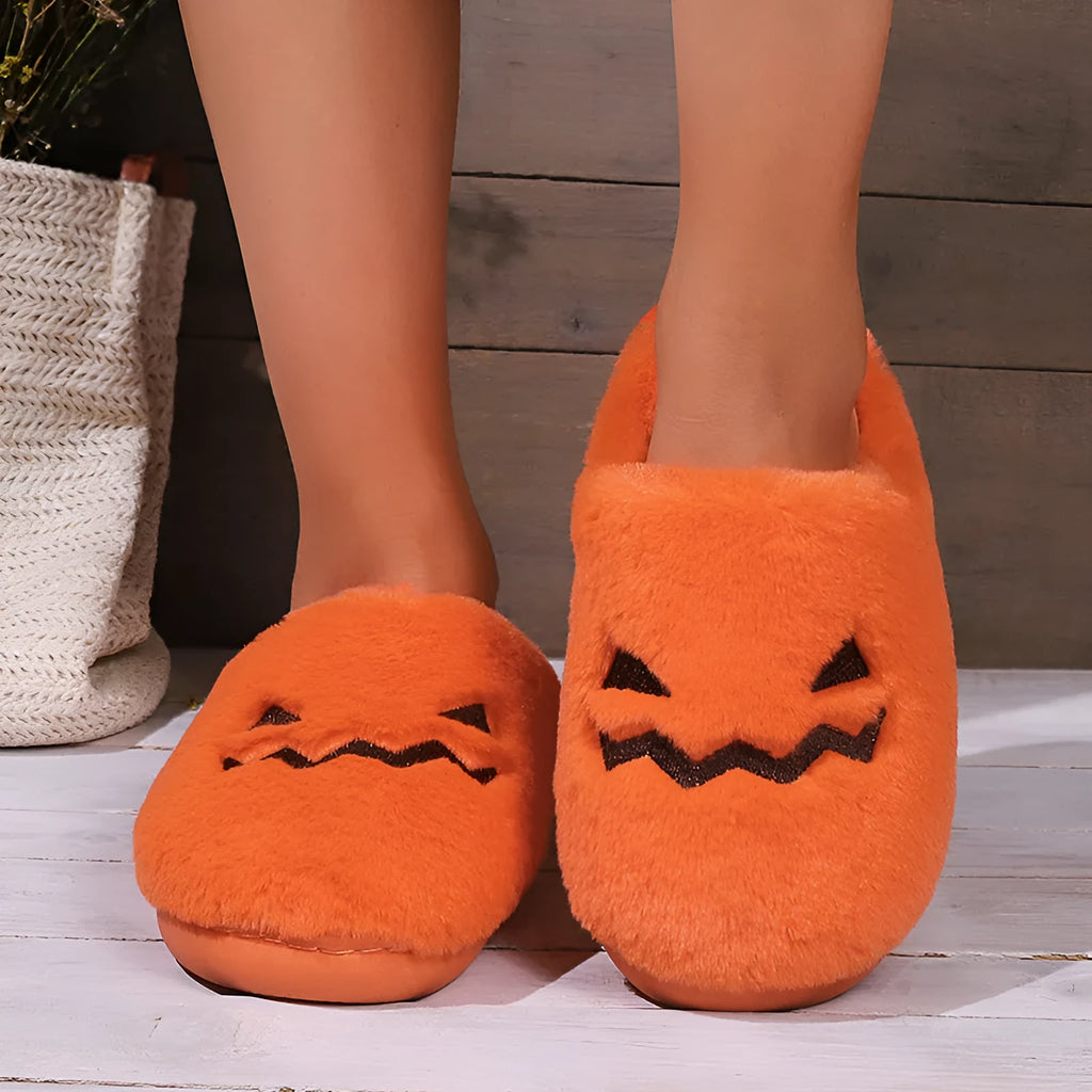 Orange Halloween pumpkin slippers with plush lining and textured PVC sole.