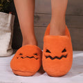 Orange Halloween pumpkin slippers with plush lining and textured PVC sole.