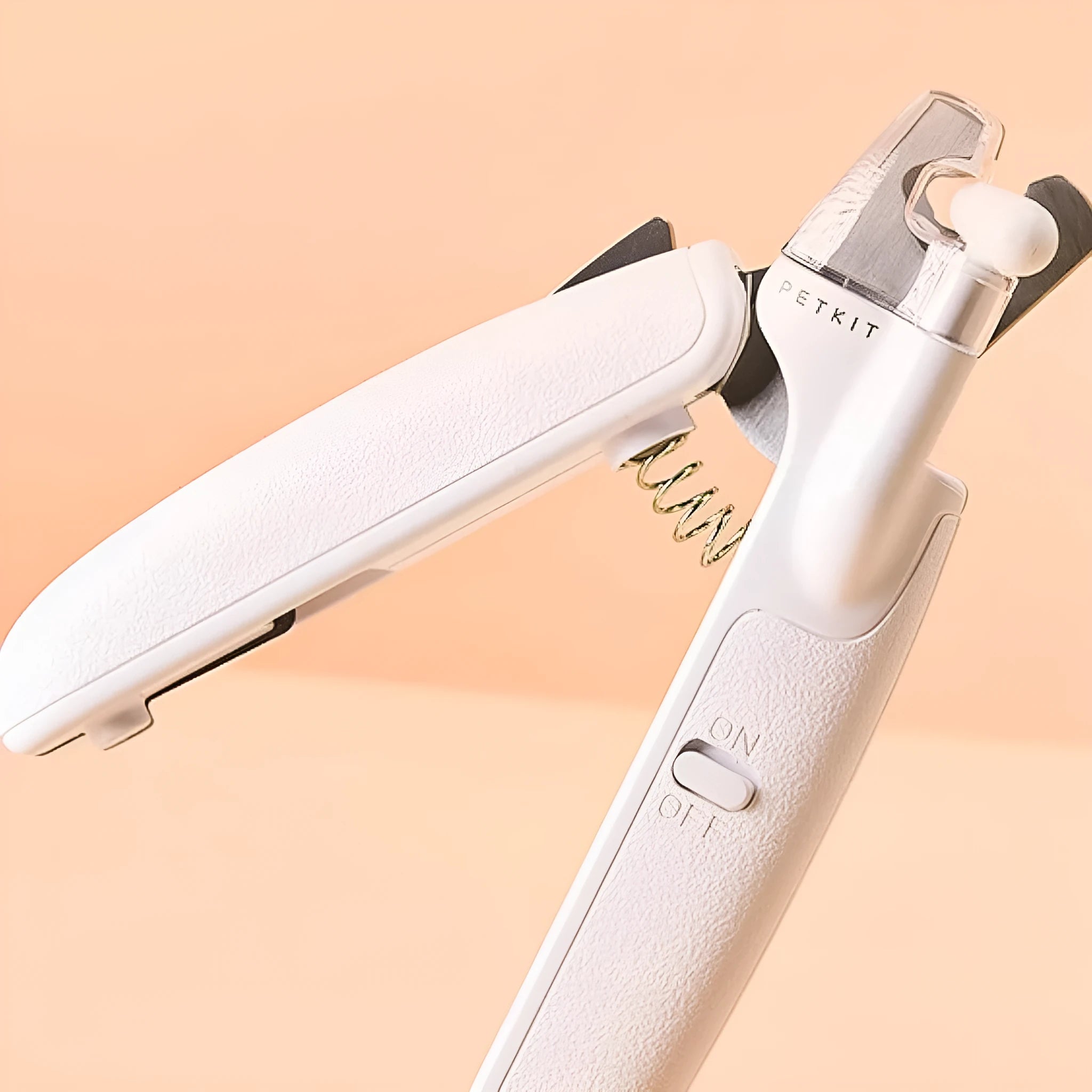 White pet nail clippers with LED light, transparent anti-splash guard open, and separate nail file.