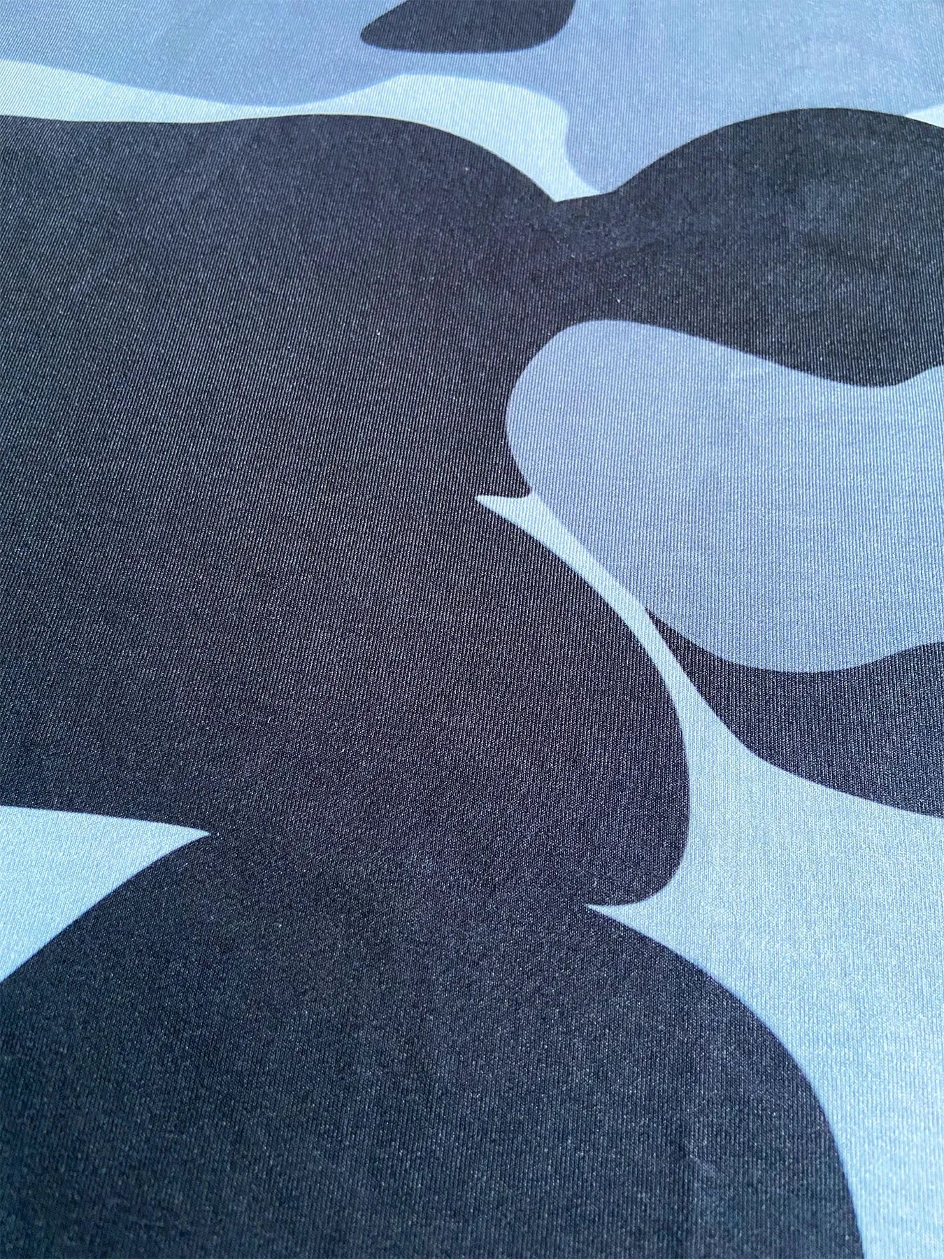 Huk long sleeve performance fishing shirt with crew neck and mesh side panels.