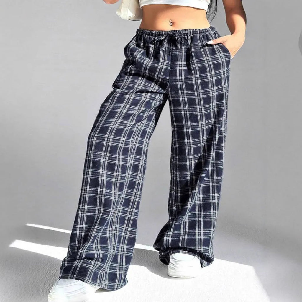 Women's loose fit plaid trousers with drawstring waist and patch pockets in casual styling